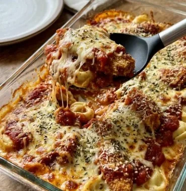 Delicious chicken parm tortellini alfredo baked dish with cheese and herbs