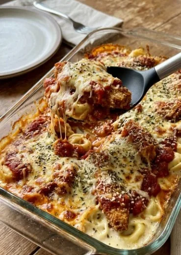 Delicious chicken parm tortellini alfredo baked dish with cheese and herbs