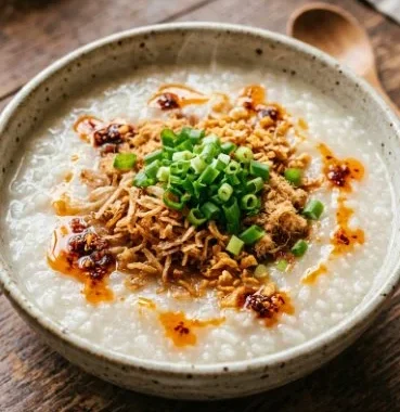 Easy Breakfast Congee 1 Bowl of easy breakfast congee topped with green onions and sesame seeds.