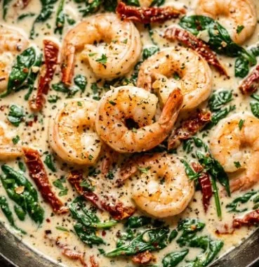 Easy Creamy Tuscan Shrimp 2 Delicious creamy Tuscan shrimp served with herbs and pasta