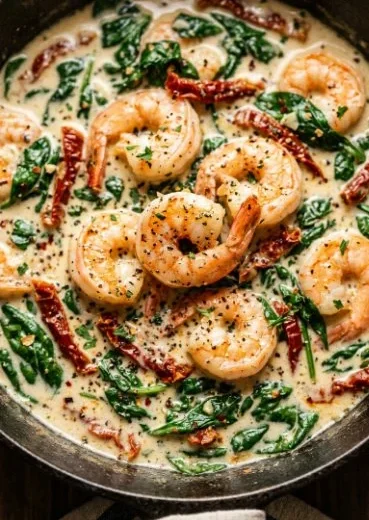 Delicious creamy Tuscan shrimp served with herbs and pasta