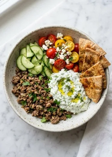 Greek ground turkey gyro bowl with fresh vegetables and tzatziki sauce