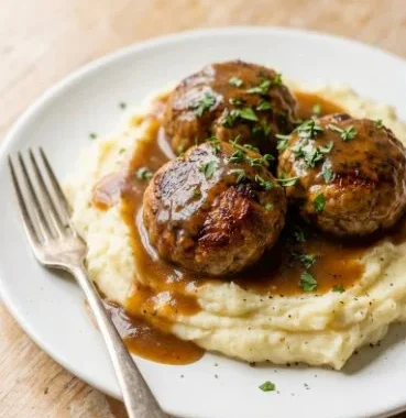Delicious meatballs served in savory gravy on a plate