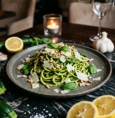 Pesto zucchini noodles topped with fresh basil and cherry tomatoes
