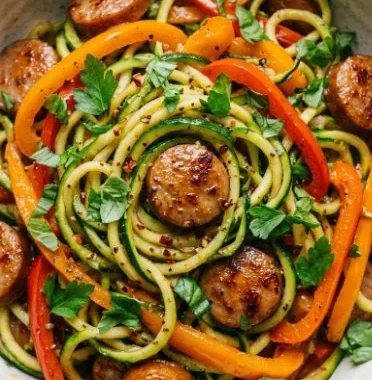 Sausage and Peppers with Zucchini Noodles 1 Delicious sausage and peppers served over zucchini noodles in a bowl