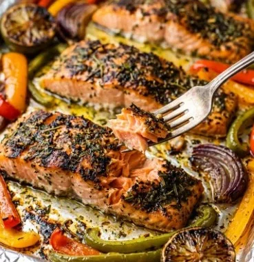 Sheet pan salmon with bell peppers and onion ready to serve
