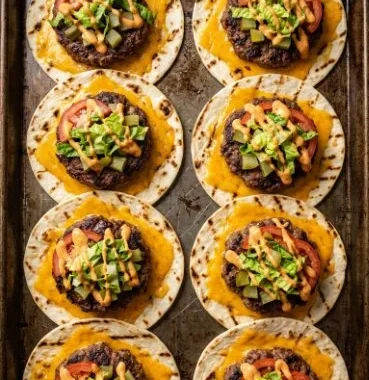 Smashed Cheeseburger Tacos 2 Delicious Smashed Cheeseburger Tacos served with toppings.