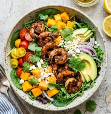 Tropical grilled shrimp salad with mango and avocado on a plate