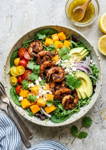 Tropical grilled shrimp salad with mango and avocado on a plate