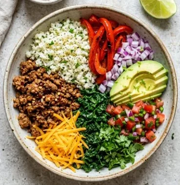 Colorful and fresh Vegetarian Burrito Bowl with beans, rice, and vegetables